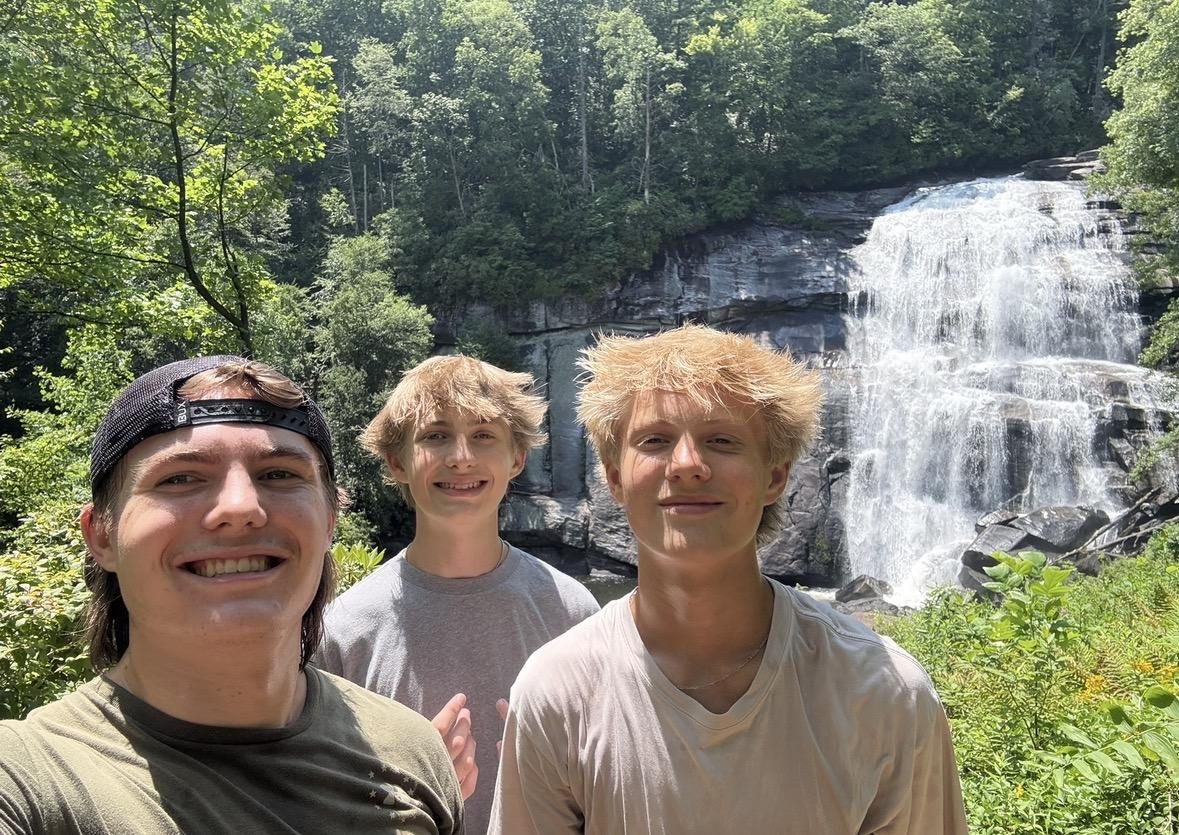 Jack hiking with his brothers near a waterfall