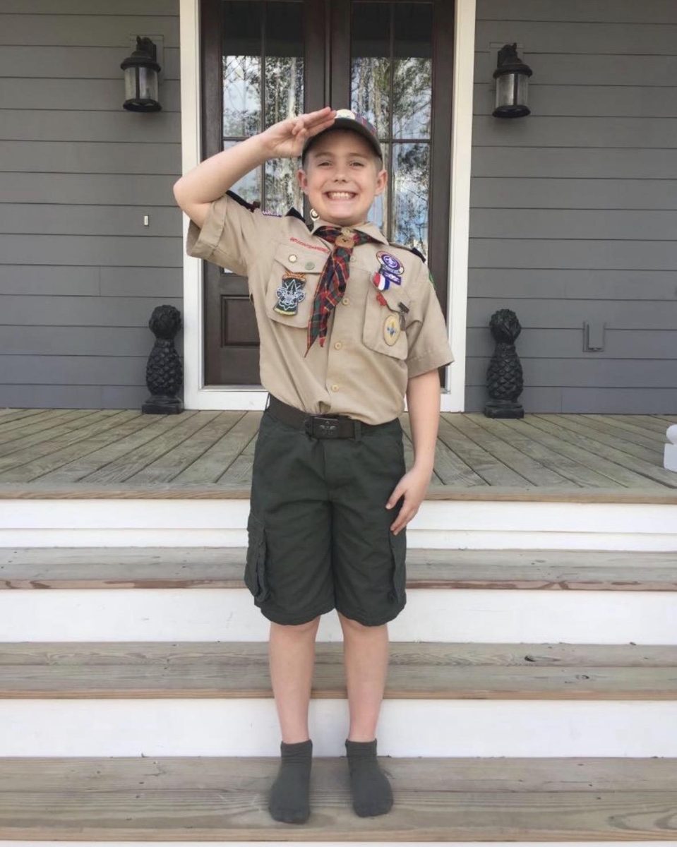 Jack as a kid saluting in his Cub Scouts uniform
