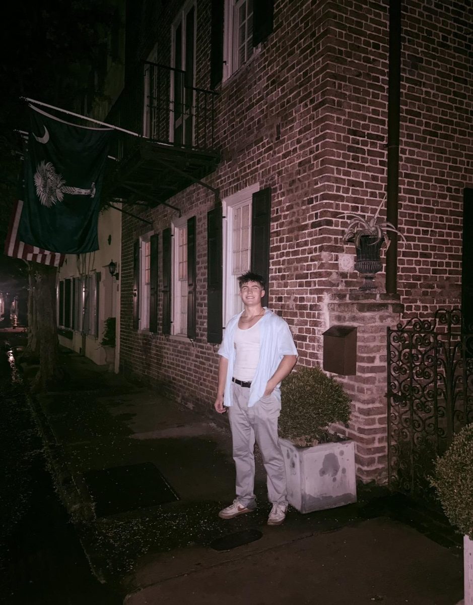 Jack downtown Charleston beside a South Carolina flag